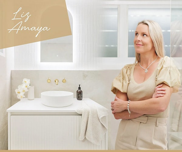 Liz Amaya radiating happiness, arms crossed, in front of the screen shower of her 极速赛车官网168 Tiles-inspired bathroom